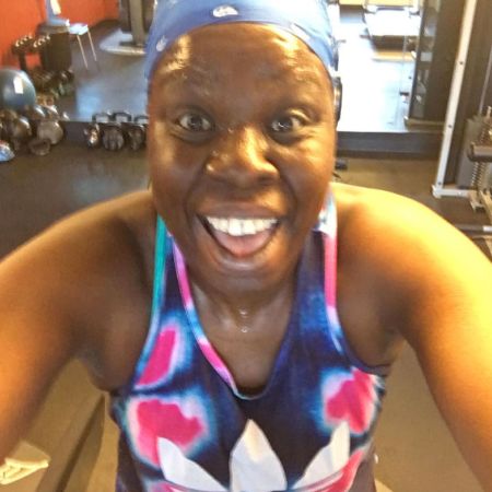 Leslie Jones all in sweat poses a picture after working out.